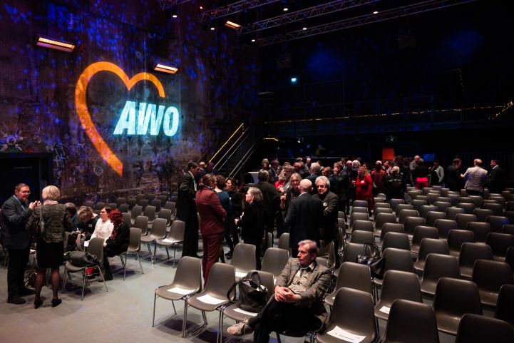 AWO Neujahrsempfang 2023: Der Saal des Kesselhauses der Kulturbrauerei füllt sich langsam. An der Wand das projizierte AWO Logo 