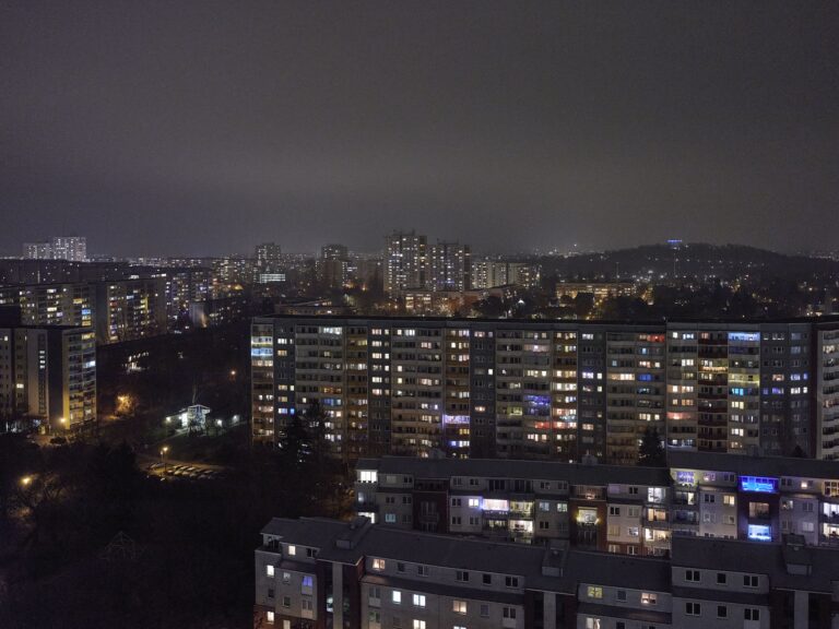 Eine Stadt mit vielen hohen Wohngebäuden bei Nacht.